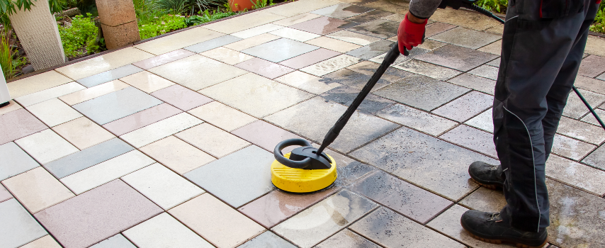 Man cleaning paved patio