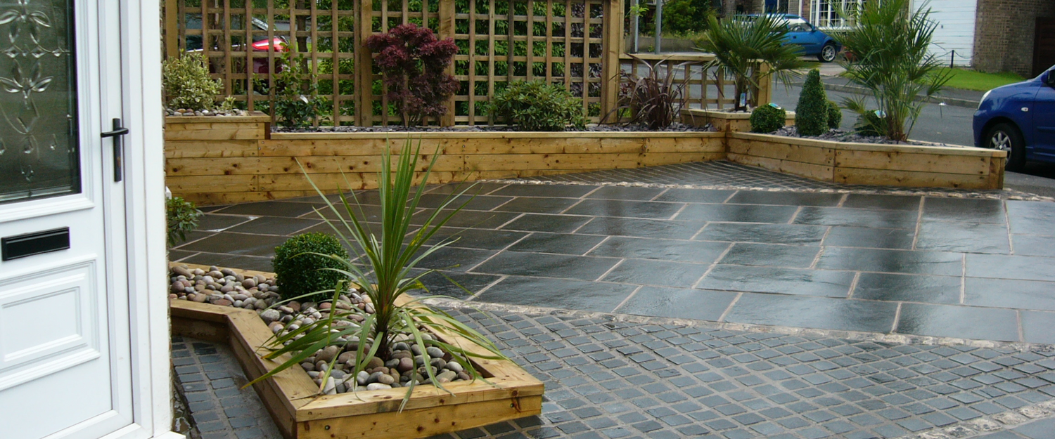 Kota Black Limestone driveway with deep black tones and a naturally riven surface, creating a sleek and durable entrance with a premium stone finish