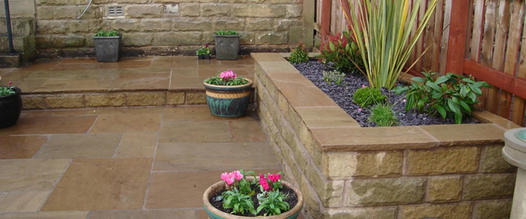 Raj Green sandstone patio – beautifully laid natural stone slabs with a traditional, warm-toned finish, enhancing any garden or outdoor space