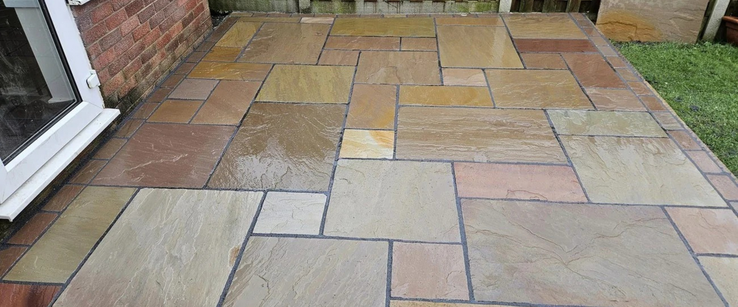 Close-up of Raj Green Indian Sandstone – showcasing its riven texture and blend of earthy tones for timeless, durable outdoor paving.