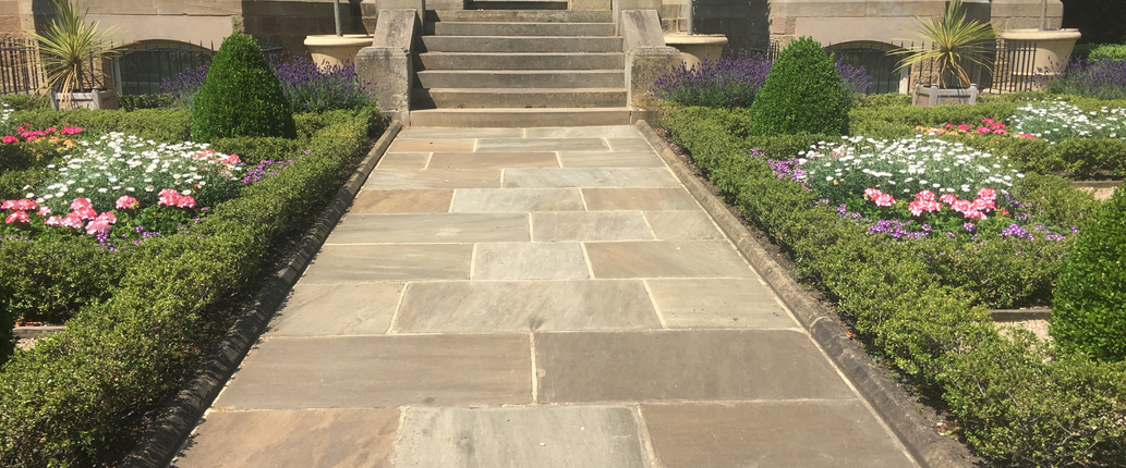 Stacked Raj Green sandstone single-size paving slabs, available to buy individually or by the pallet for complete project flexibility